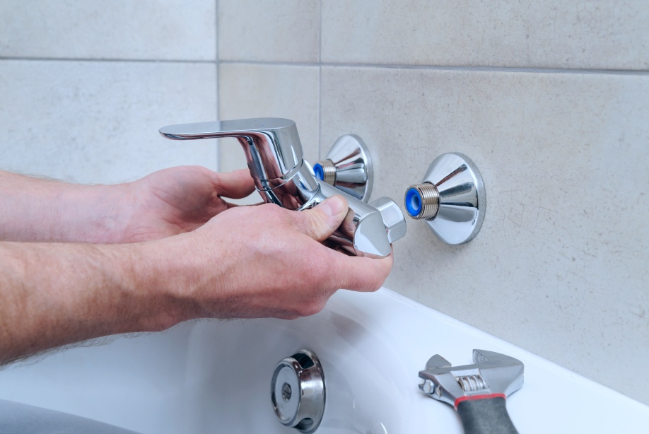 Plumber-holding-a-bath-faucet-and-installs-it-beaumont-ca